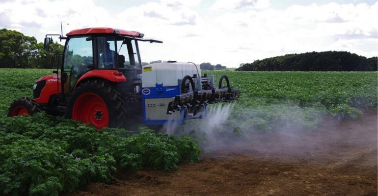 Hero image tractor spraying onto a field